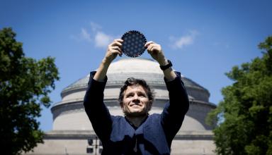 Pablo standing in front of MIT dome holding wafer