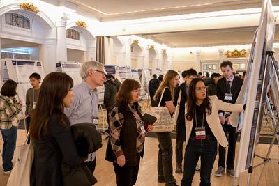 Student shows research to group of people