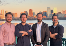 4 men standing in front of city skyline