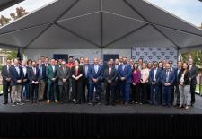 group of men and women standing together on a stage