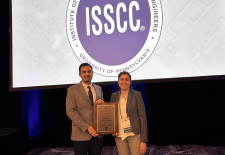 man and woman pose with award 