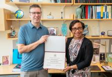 man and woman standing holding award certificate