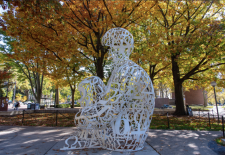 statue in front of orange leaves
